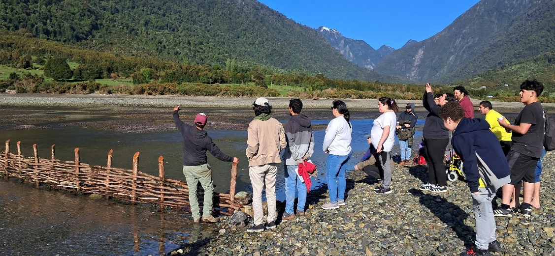 Foto: Ricardo Álvarez, 2024. Comunidad dialogando junto a los avances de su corral de pesca en Buill